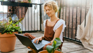 Woman on laptop with plants