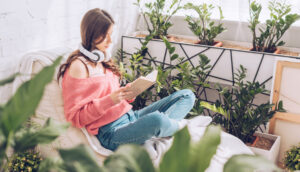 Woman reading surrounded by plants