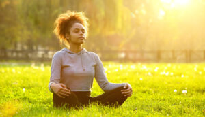 Woman meditating in a park
