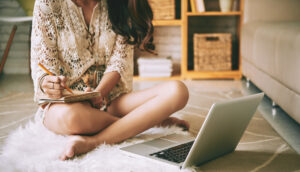 Woman on floor writing