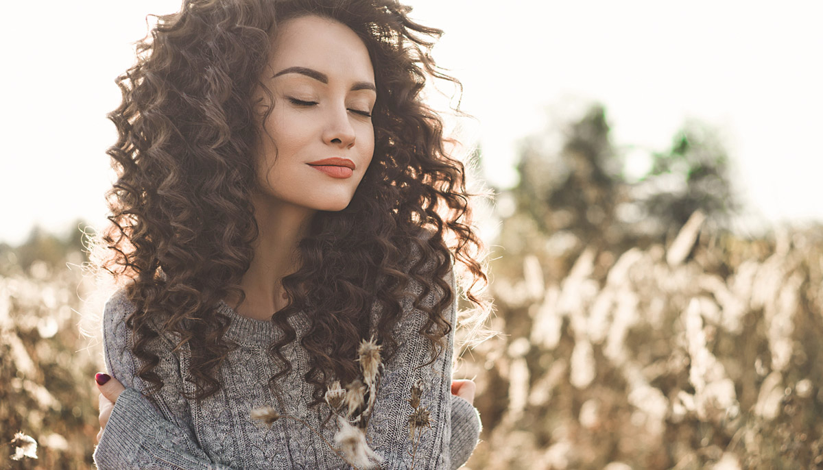 Curly haired woman in a field